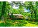 View of home with natural surroundings and large wood deck at 2738 Westminister Nw Ln, Conyers, GA 30012