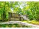 A charming home features a front yard, two-car garage, and a stairway to the entrance at 2738 Westminister Nw Ln, Conyers, GA 30012