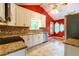 Bright kitchen with stainless steel dishwasher and sink, granite counters, and mosaic backsplash at 2738 Westminister Nw Ln, Conyers, GA 30012