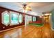 Spacious living room featuring beautiful wood floors, unique windows, and a ceiling fan at 2738 Westminister Nw Ln, Conyers, GA 30012
