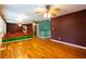 Bright living room with wood floors, wall mirrors with unique artwork, and ceiling fan at 2738 Westminister Nw Ln, Conyers, GA 30012