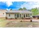 Back exterior featuring a level yard, patio area, and mature landscaping at 4460 Delano Dr, Cumming, GA 30040