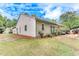 Exterior rear view of home with patio area, partial shade, and lawn at 4460 Delano Dr, Cumming, GA 30040