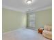 Clean and serene bedroom with a large window, neutral walls, and plush carpeting for a calming and comfortable ambiance at 4460 Delano Dr, Cumming, GA 30040