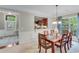 Cozy dining room with wood table and chairs, abundant natural light, and an open view into the kitchen at 4460 Delano Dr, Cumming, GA 30040