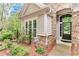 Home's entrance with manicured landscaping and brick accents, offering great curb appeal at 4460 Delano Dr, Cumming, GA 30040