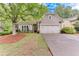 Charming single Gathering home featuring stone accents, an attached two car garage, and a well-manicured front yard at 4460 Delano Dr, Cumming, GA 30040