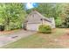 Traditional home boasting a two-car garage, meticulously maintained lawn, and mature trees for added privacy at 4460 Delano Dr, Cumming, GA 30040