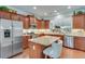 Modern kitchen featuring stainless steel appliances, granite countertops, an island with seating, and custom cabinetry at 4460 Delano Dr, Cumming, GA 30040