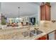 The kitchen features granite countertops, stainless steel appliances and custom cabinets adjacent to the living room at 4460 Delano Dr, Cumming, GA 30040