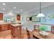 Bright eat-in kitchen features an island with granite countertops and stainless steel appliances at 4460 Delano Dr, Cumming, GA 30040