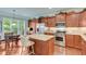 Well-appointed kitchen with granite countertops, stainless steel appliances, an island, and natural light at 4460 Delano Dr, Cumming, GA 30040