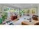 Bright sunroom featuring large windows, tiled floor, and comfortable seating, perfect for relaxation and enjoying the view at 4460 Delano Dr, Cumming, GA 30040