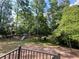 Large backyard with mature trees and play set, perfect for outdoor fun and relaxation at 1343 Peachtree Battle Nw Ave, Atlanta, GA 30327