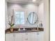 Charming bathroom features a vanity with granite countertop, white cabinets, and decorative mirror and hardware at 1343 Peachtree Battle Nw Ave, Atlanta, GA 30327