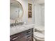 Modern bathroom features a marble countertop, dark vanity, gold accents, and a glass-enclosed shower at 1343 Peachtree Battle Nw Ave, Atlanta, GA 30327