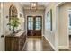 Traditional home entryway featuring hardwood floors, a decorative mirror, lamp, and a glimpse into the living spaces at 1343 Peachtree Battle Nw Ave, Atlanta, GA 30327