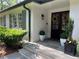 Close up of the front door, featuring sidelights, a beautiful wreath, and tasteful landscaping and planters for a welcoming entry at 1343 Peachtree Battle Nw Ave, Atlanta, GA 30327