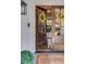 Close-up of the inviting, glass paneled front door with yellow wreaths, opening into the living area. A small dog is waiting inside at 1343 Peachtree Battle Nw Ave, Atlanta, GA 30327