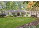 Charming traditional home with a manicured lawn, symmetrical landscaping, and a welcoming facade with many windows at 1343 Peachtree Battle Nw Ave, Atlanta, GA 30327