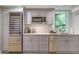 Charming kitchenette features stainless steel appliances, gray cabinetry, and natural light at 1343 Peachtree Battle Nw Ave, Atlanta, GA 30327