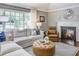 Comfortable living room with a fireplace, large window, neutral color scheme, and stylish decor creating a warm atmosphere at 1343 Peachtree Battle Nw Ave, Atlanta, GA 30327