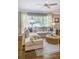 Cozy living room featuring a plush sectional sofa, large window, and stylish decor creating an inviting space for relaxation at 1343 Peachtree Battle Nw Ave, Atlanta, GA 30327