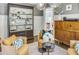 Well-appointed living room with a dark wood china cabinet, seating, stylish decor, and view into the bright and functional kitchen at 1343 Peachtree Battle Nw Ave, Atlanta, GA 30327