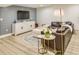 Modern living room with shiplap wall, hardwood floors, a large sectional, and a decorative white credenza at 1343 Peachtree Battle Nw Ave, Atlanta, GA 30327