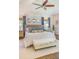 Bright main bedroom features a tufted headboard, sitting area, hardwood floors, and natural light from the windows at 1343 Peachtree Battle Nw Ave, Atlanta, GA 30327