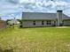Expansive backyard featuring a well-maintained lawn, landscaping, and privacy at 19 Windcrest Dr, Covington, GA 30016