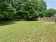 Large, grassy backyard with a mix of sun and shade, perfect for recreation at 19 Windcrest Dr, Covington, GA 30016