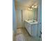 Well-lit bathroom with double sinks and a large mirror, combining style and functionality at 19 Windcrest Dr, Covington, GA 30016