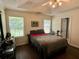 Inviting bedroom featuring natural light, a cozy bed and an access door to a bathroom at 19 Windcrest Dr, Covington, GA 30016