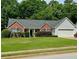 Charming single-story home with brick accents, a well-manicured lawn, and a two-car garage at 19 Windcrest Dr, Covington, GA 30016