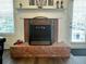Traditional brick fireplace with white mantle, providing a cozy focal point in the living area at 19 Windcrest Dr, Covington, GA 30016