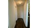 Inviting hallway with hardwood floors, leading to a white door, and a warm, welcoming ambiance at 19 Windcrest Dr, Covington, GA 30016