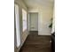 Hallway with natural light and hardwood floors that leads to a bright living space at 19 Windcrest Dr, Covington, GA 30016