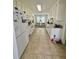 Traditional kitchen with white cabinets and tile flooring, bathed in natural light at 19 Windcrest Dr, Covington, GA 30016