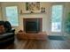 Inviting living room with a traditional fireplace, hardwood floors and bright windows at 19 Windcrest Dr, Covington, GA 30016