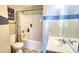 A bathroom features tile floors, a shower with tub, and a sink at 2000 Redwood Trce, Ellenwood, GA 30294
