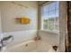 Relaxing soaking tub area with natural light from a window at 2000 Redwood Trce, Ellenwood, GA 30294