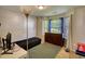 Cozy bedroom featuring a double window for ample sunlight, a dresser, and carpeted floors at 2000 Redwood Trce, Ellenwood, GA 30294