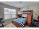 Bedroom with a loft bed that features built-in storage, natural light, and wall art at 2000 Redwood Trce, Ellenwood, GA 30294