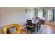 Bright dining area featuring a wooden table, seating for six, and access to the kitchen at 2000 Redwood Trce, Ellenwood, GA 30294