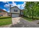 Charming two-story home with brick and siding, featuring an attached garage and well-manicured lawn and cloudy sky at 2000 Redwood Trce, Ellenwood, GA 30294