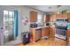 Functional kitchen with stainless steel appliances, ample cabinet space, and access to the outdoors at 2000 Redwood Trce, Ellenwood, GA 30294