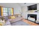 Comfortable living room featuring a plush sofa, fireplace, and natural light at 2000 Redwood Trce, Ellenwood, GA 30294