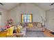 Comfortable living room with vaulted ceilings, inviting sofa, and natural light streaming through the window at 2000 Redwood Trce, Ellenwood, GA 30294