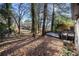 View of the spacious backyard with mature trees and patio/deck in the distance at 2814 Lloyd Rd, Decatur, GA 30034